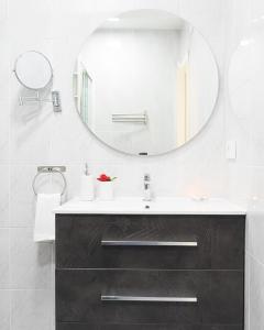 a bathroom with a sink and a mirror at Lux&Cool Obispo Orberá - Santa Rita in Almería