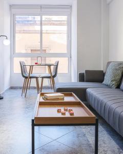 a living room with a couch and a table at Lux&Cool Obispo Orberá - Santa Rita in Almería