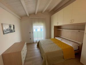 Postel nebo postele na pokoji v ubytování Residence Gianka - Agenzia Cocal