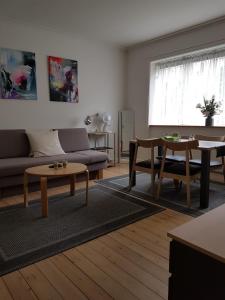 a living room with a couch and a table at TosleepinCPH in Copenhagen