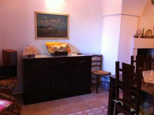 a room with a wooden cabinet with a painting on the wall at villa ottocento in Ostuni