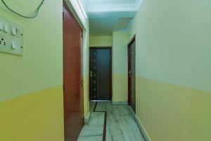 an empty hallway with a door in a room at FabHotel Yatika Residency in Kolkata +21 photos