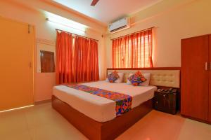 a bedroom with a large bed in a room at FabHotel Capital Casa in Kolkata