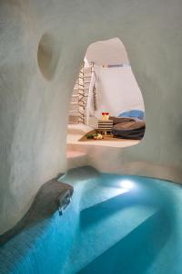 a room with a swimming pool in a house at Mystagoge Retreat with subterranean pool/jacuzzi in Vóthon