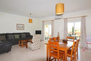 a living room with a couch and a table at Falésia Marina - Clever Details in Vilamoura