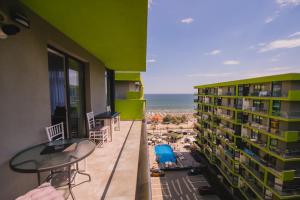 a balcony with a view of the beach and a building at Cermar Apartment- Spa n Pool beach resort- parking in Mamaia