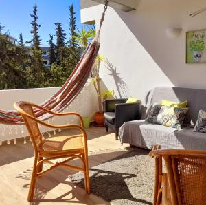 a hammock in a living room with a couch at ExcelStay - Balaia in Albufeira