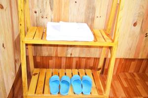 a sauna with three blue slippers on a shelf at Mu Cang Chai Homestay & Trekking in Mù Cang Chải +108 photos