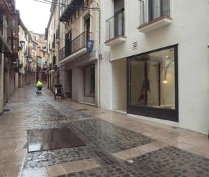 an empty street with a man walking down the street at HOTEL LA FONDA B&B in Tarazona de Aragón