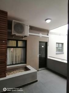 a living room with a air conditioner on the wall at Urban Park Private Apartment in Durban