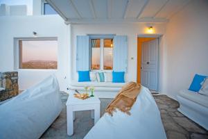 a living room with a couch and a table at Villa BiancaRosa with amazing views! in Mikonos
