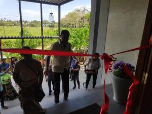 a group of people walking down a hallway with a red ribbon at Sooriya Wessagiri Resort in Anuradhapura