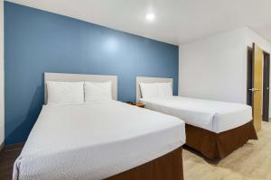 Krevet ili kreveti u jedinici u okviru objekta WoodSpring Suites Conroe