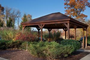 a wooden gazebo in a garden at Sonesta Simply Suites Cleveland North Olmsted Airport in North Olmsted