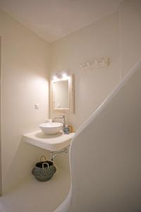 a white bathroom with a sink and a staircase at Villa BiancaRosa with amazing views! in Mikonos +31 photos