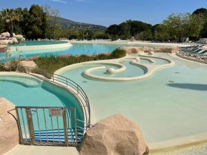 a large pool with a slide in a water park at Les Restanques - Grimaud in Grimaud