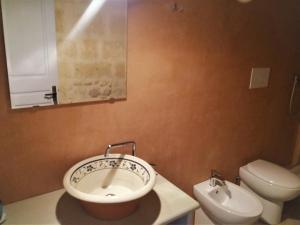 a bathroom with a sink and a toilet at Bed & Breakfast Casa Lopez in Barletta