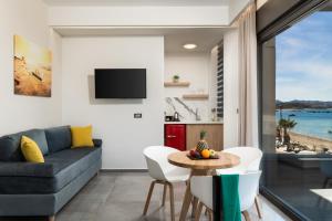 a living room with a couch and a table at Archin Boutique suites in Chania