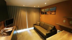 a living room with a couch and a television at middelkerke - frontaal zeezicht in Middelkerke