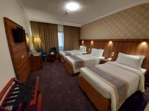 Postel nebo postele na pokoji v ubytování Saraya Harmony Hotel C