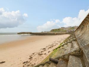 a view of a beach with a retaining wall at Dookers' Hoose in Buckie