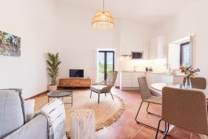 ein Wohnzimmer mit einem Sofa und einem Tisch in der Unterkunft Quinta da Baleeira in Tavira