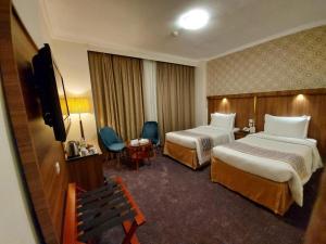 Postel nebo postele na pokoji v ubytování Saraya Harmony Hotel C