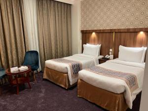 Postel nebo postele na pokoji v ubytování Saraya Harmony Hotel C