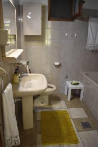 a bathroom with a sink and a toilet and a tub at Apartments Renata in Pučišća +84 photos