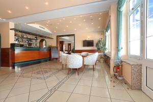 a dining room with a table and chairs at Hotel Mediteran in Zadar