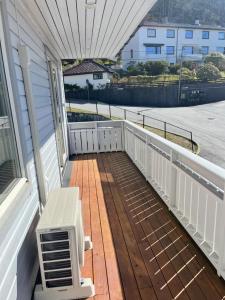 a porch with a bench on a balcony at Ulriken Apartment in Bergen