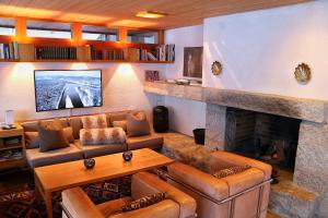 a living room with a couch and a fireplace at Chalet Morgane in Grindelwald
