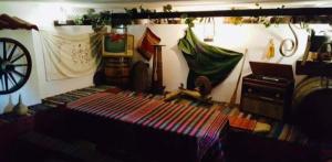 a room with a bed and hammocks on a wall at Guest House Sofia in Sandanski
