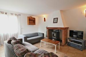a living room with a couch and a fireplace at La Panadería at Molino la Ratonera in Granada