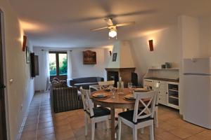 a kitchen and living room with a table and chairs at La Panadería at Molino la Ratonera in Granada