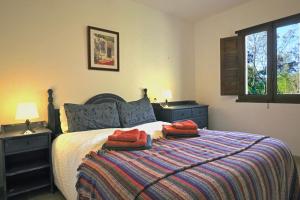 a bedroom with a bed with two red pillows on it at La Panadería at Molino la Ratonera in Granada +8 photos