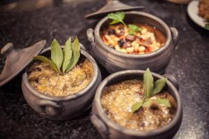 a group of four small pots with plants in them at Quinta dos Padres Santos, Agroturismo & Spa in Lamego