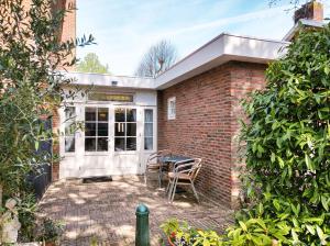 a brick house with a patio with a table and chairs at Studio with sauna in Amsterdam