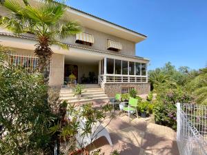 ein Haus mit einer Palme davor in der Unterkunft Stunning 5 bed Villa La Font, private pool in El Campello