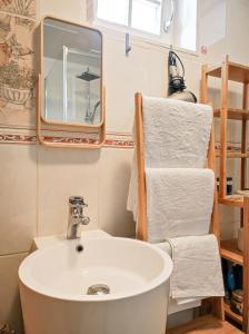a bathroom with a sink and a mirror and towels at Studio with sauna in Amsterdam
