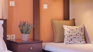 a bedroom with a bed and a vase of flowers at House Chrysoula Mitsokopi in Sarti