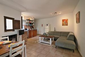 a living room with a couch and a table at El Granero at Molino la Ratonera in Zagra
