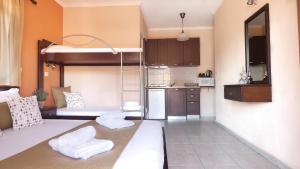 a living room with a bunk bed and a kitchen at House Chrysoula Mitsokopi in Sarti