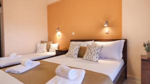 a bedroom with two beds with towels on them at House Chrysoula Mitsokopi in Sarti