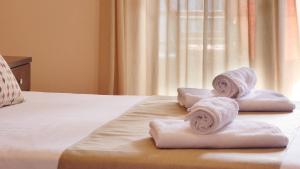 a hotel room with towels on a bed at House Chrysoula Mitsokopi in Sarti