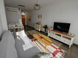 sala de estar con sofá y TV de pantalla plana en VeraTespera - Apartamento en Vera Playa - Mascotas, en Vera