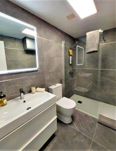 a bathroom with a toilet and a sink and a shower at Apto El Faro Puerto Deportivo in Marbella
