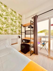 a bedroom with a bed and a balcony at Nanit Rooms Ibiza Hostal in Santa Eularia des Riu