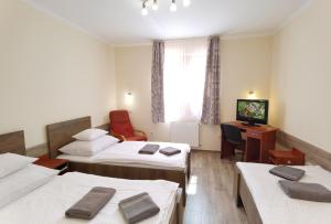 A bed or beds in a room at Kamilla Panzió és Rendezvényház