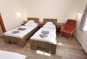 A bed or beds in a room at Kamilla Panzió és Rendezvényház